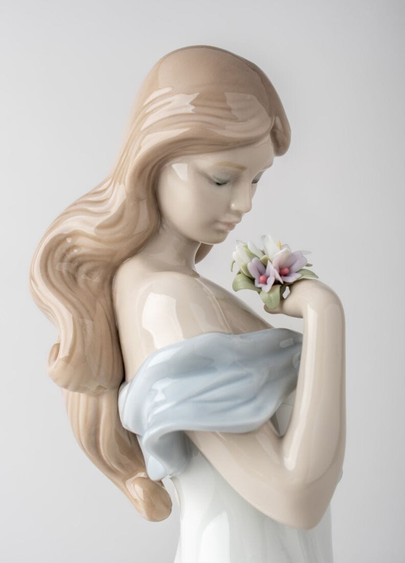 A Flower's Whisper Woman Figurine in Lladró