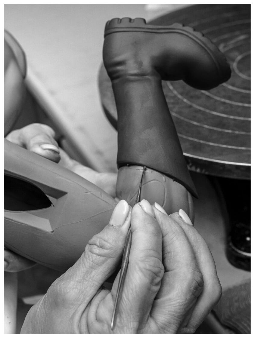 A person working on a pair of boots for Batman