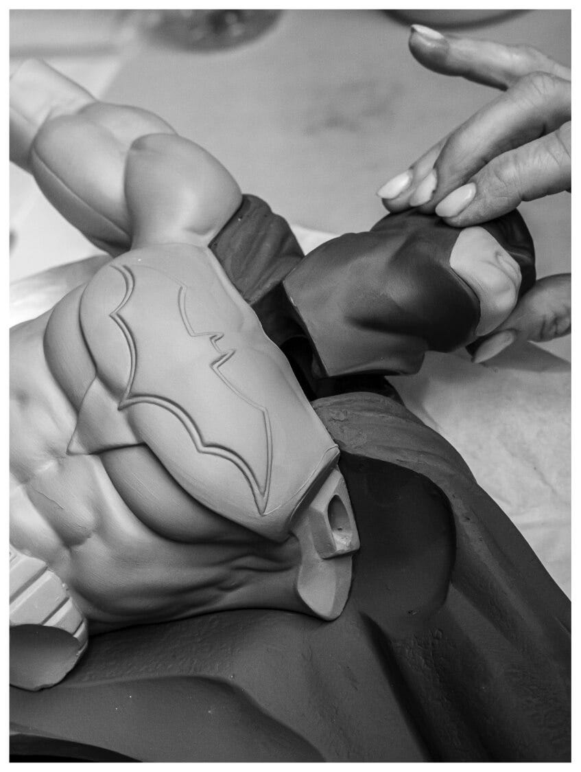 Person assembling Batman's head